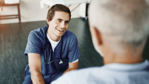 Male clinician smiling up at patient